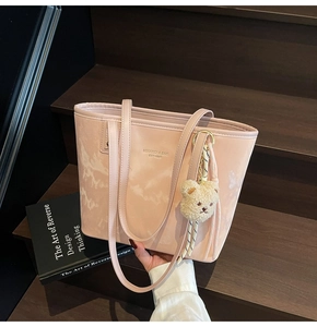 Pink bucket tote bag with marble texture and bear charm on wooden stairs backdrop