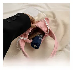 Spacious interior of pink corduroy tote bag showing capacity for phone and umbrella