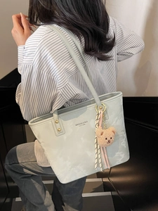 Light blue marbled tote bag with plush bear pendant and dual straps for women