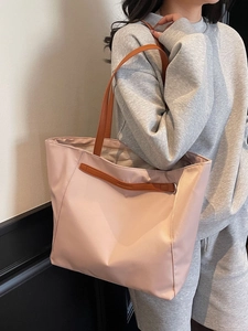 Large pink oxford cloth tote bag with brown leather handles and spacious interior