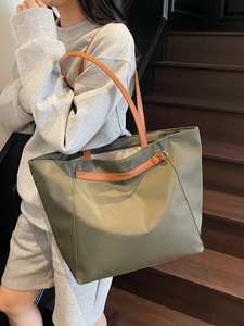 Olive green Oxford cloth tote bag with brown leather handles for daily commute