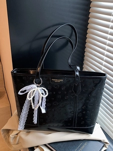 Black leather tote bag with rose embossed pattern and white lace pearl bow charm