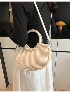 Cream pleated half-moon bucket bag with round handle and adjustable shoulder strap