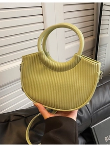 Minimalist light green pleated bucket bag with round handle and adjustable shoulder strap