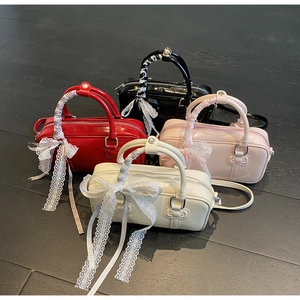 Glossy patent leather mini handbags in red, black, pink, and white with cat relief decor