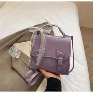 Detailed view of the purple PU leather bag with lace ribbon and 3D bow accents