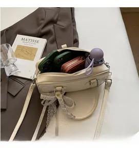 Interior view of cream white Boston bag showing space for phones, wallet and umbrella