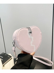 Classic heart shaped crossbody bag in soft pink with white zigzag pattern and silver hardware