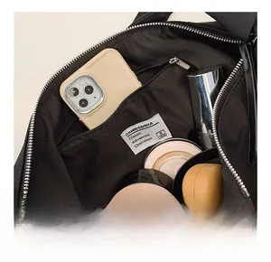 Detail of spacious interior compartment with zip pocket and daily essentials inside