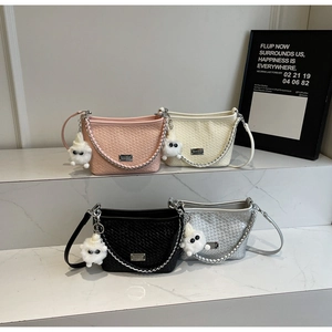 Detail of woven faux leather shoulder bags in four colors with fluffy monster charms