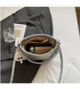 Spacious interior of silver hobo bag showing multiple daily essentials and lining