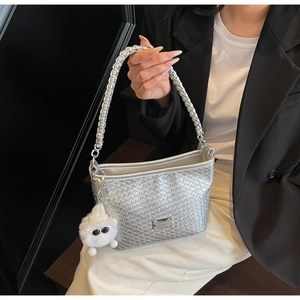 Detail of silver woven texture faux leather underarm bag with cute plush pendant accessory