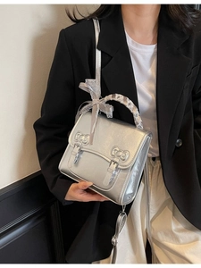 Silver PU leather backpack for women with bow accents and white lace ribbon handles