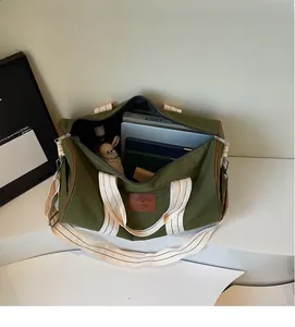 Top view of olive canvas travel bag showing large interior capacity for laptop and books