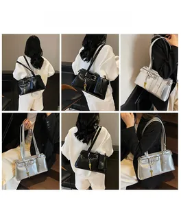 Fashionable shoulder bags in black and silver featuring decorative belts and key charms