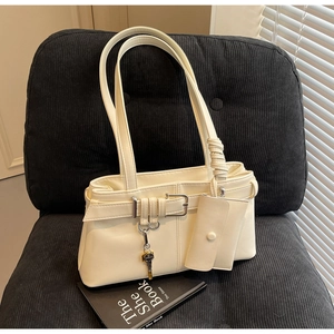 Detail of cream PU leather shoulder bag with silver buckle and mini flap pouch attachment