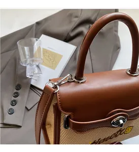 Detailed shot of textured beige woven handbag with brown leather flap and silver clasp lock