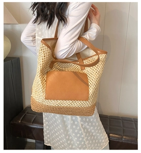 Detailed view of handmade straw woven tote bag with brown leather pocket and straps