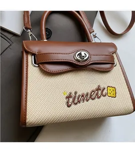 Close-up of beige woven texture and brown leather details with metallic silver lock
