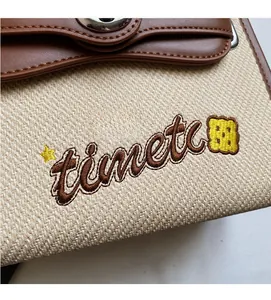 Close-up of contrast stitching canvas and brown leather texture on stylish handbag