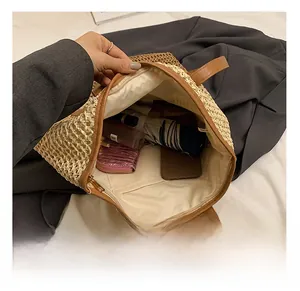 Interior view of straw tote bag showing large capacity for daily essentials and lining