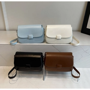 Collection of four vintage leather crossbody bags in blue, white, black, and brown