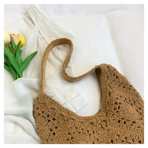 Detailed close-up of handmade crochet hollow floral patterns on a cotton tote bag