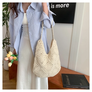 Detail of off-white handmade crochet shoulder bag with intricate hollow diamond weave