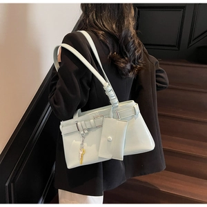 Detail of mint green shiny faux leather tote with matching mini pouch and key charm