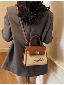 Brown and beige patchwork handbag with adjustable crossbody strap shown on model