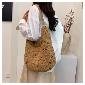Close-up of handmade crochet flower patterns on this bohemian hollow knit tote bag