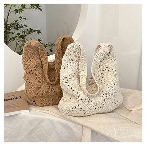 Close-up of bohemian crochet flower pattern on hollow knit shoulder tote bag