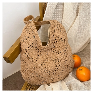 Detailed macro view of handmade crochet tote bag with intricate floral weave patterns