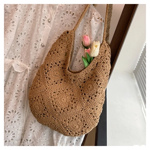 Close-up of brown crochet tote bag featuring intricate floral openwork pattern details