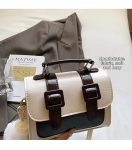 Detail of vintage oil wax leather Cambridge bag with fluffy charm and strap