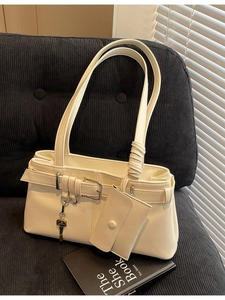 Creamy PU leather tote bag with decorative buckle and small coin purse on a soft sofa
