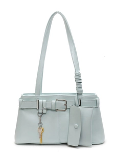 Minimalist light blue faux leather tote bag with small pouch and key charms on white background