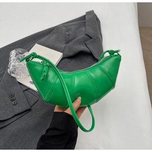 Detail view of bright green crescent bag with pleated faux leather and knot strap accents