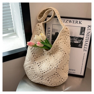 Detailed close-up of hollowed-out crochet flower pattern on a cream-white cotton tote bag