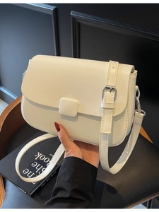 White minimalist saddle crossbody bag with silver buckle and adjustable shoulder strap