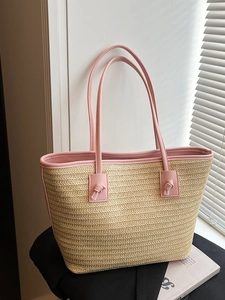 Sac cabas en paille tressée beige avec anses en cuir rose pour les vacances d'été