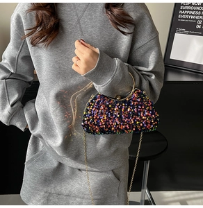 Close-up of colorful sequin evening bag with a gold metal handle and chain strap