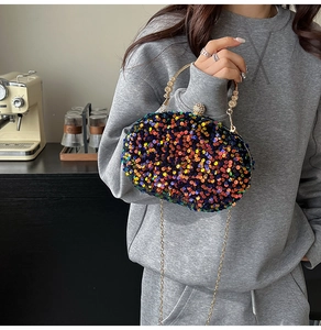 Rainbow sequin evening clutch bag with round metal handle and sparkling rhinestone clasp