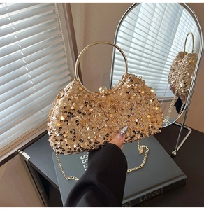 Detailed macro view of golden sequin evening clutch bag with metal handle and chain strap