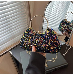Detail of colorful sequins and gold ring handle on elegant evening clutch bag