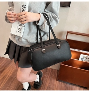 Detail view of black lychee grain faux leather Boston bag with silver hardware