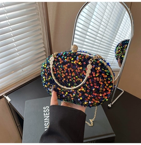 Detail of colorful sequin evening clutch bag with floral engraved handle and rhinestone clasp