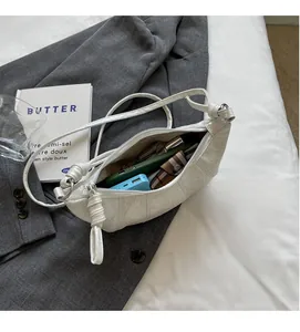 Top view of white croissant bag showing large interior capacity with zipper closure