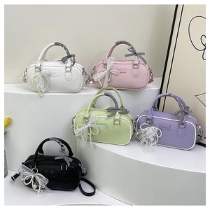 Detailed row of various colored bowling handbags with checkered bows and lace charms