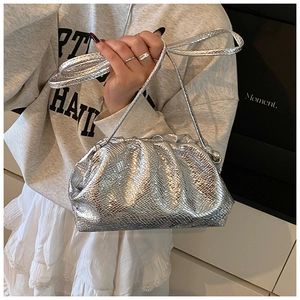Detail of silver snake-textured drawstring bag with metallic finish and pleated design